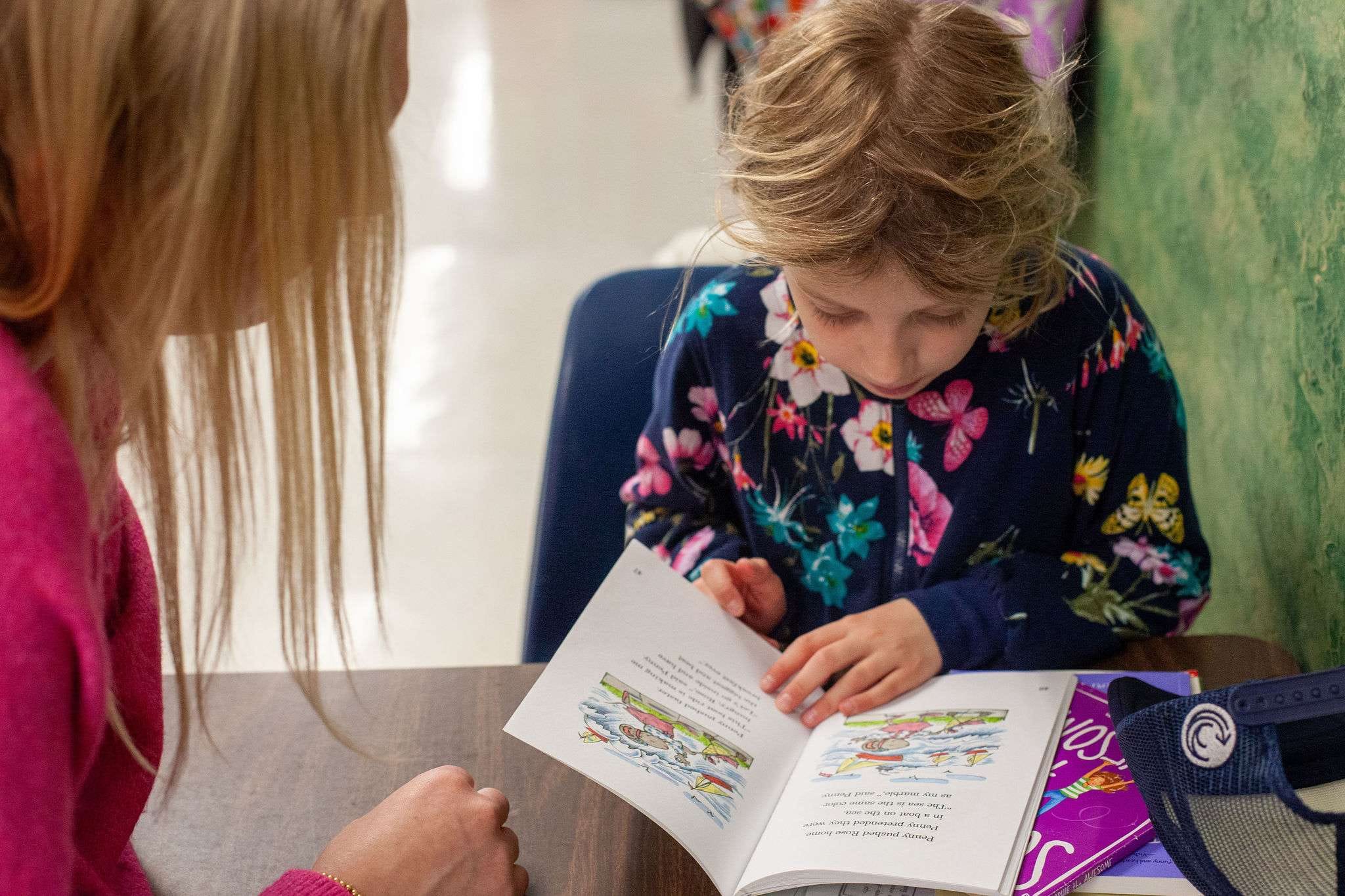 A ROW volunteer and student reading together